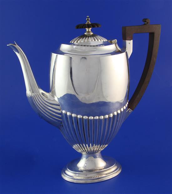An Edwardian demi-fluted silver pedestal coffee pot, by Walker & Hall, 24.5 oz.